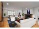Spacious living room with hardwood floors, large windows, fireplace, and adjacent dining area, great for entertaining at 844 N Humboldt St # 5, Denver, CO 80218
