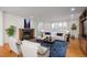 Bright living room featuring a fireplace, hardwood floors, and a large window letting in natural light at 844 N Humboldt St # 5, Denver, CO 80218