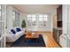 Inviting living room with hardwood floors, a modern sofa, a mini-bar, and bright windows overlooking the outdoors at 844 N Humboldt St # 5, Denver, CO 80218