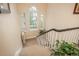 Bright staircase features large windows, neutral carpet, and a white banister leading to the upper level at 844 N Humboldt St # 5, Denver, CO 80218