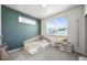 Cozy bedroom with a large window, soft natural light, and playful decor at 2004 Foxtail Ln # B, Lafayette, CO 80026