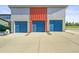 Three-car garage with blue doors and concrete driveway at 2004 Foxtail Ln # B, Lafayette, CO 80026