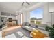 Open-concept living space with a gray sofa, large windows and access to the kitchen at 2004 Foxtail Ln # B, Lafayette, CO 80026