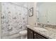 Cozy bathroom featuring a vanity with granite counter and shower with butterfly curtain at 4564 N Picadilly Ct, Aurora, CO 80019