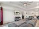 Open-concept living room featuring a comfortable sofa, a mounted TV, and a view into other areas of the home at 4564 N Picadilly Ct, Aurora, CO 80019