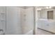 Clean bathroom with white tile shower, double sink vanity and modern lighting at 13477 Valentia St, Thornton, CO 80602
