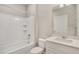A clean bathroom featuring a shower-tub combo, sleek vanity, and modern fixtures at 13477 Valentia St, Thornton, CO 80602