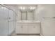 Bright bathroom with a large shower, double vanity sinks, and neutral tiling at 13477 Valentia St, Thornton, CO 80602
