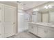 Bathroom with a large glass shower, double vanity sinks, and neutral tiling at 13477 Valentia St, Thornton, CO 80602