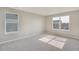 Spacious bedroom with two windows offering neighborhood views and neutral carpeting at 13477 Valentia St, Thornton, CO 80602