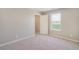 Cozy bedroom features carpet, neutral walls, a window, and a convenient doorway at 13477 Valentia St, Thornton, CO 80602