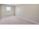 Bright bedroom with a window offering natural light and neutral carpeting at 13477 Valentia St, Thornton, CO 80602