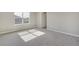 Bright bedroom with a window, neutral carpet and fresh paint, and a closet door at 13477 Valentia St, Thornton, CO 80602