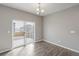 A naturally lit dining room with sliding glass doors and modern flooring at 13477 Valentia St, Thornton, CO 80602