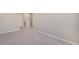 Hallway with fresh paint, trim, and neutral carpet leading to other rooms at 13477 Valentia St, Thornton, CO 80602