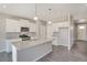 Modern kitchen with white cabinets, stainless steel appliances, granite countertops and a central island at 13477 Valentia St, Thornton, CO 80602