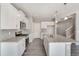 A modern kitchen with stainless steel appliances, granite countertops, and ample cabinet space at 13477 Valentia St, Thornton, CO 80602