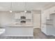 Well-lit kitchen featuring a central island, granite countertops, and modern stainless steel appliances at 13477 Valentia St, Thornton, CO 80602