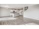 Open-concept living space featuring modern kitchen with island and a view of the stairway at 13477 Valentia St, Thornton, CO 80602