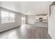 Open-concept living space featuring modern kitchen with island and abundant natural light at 13477 Valentia St, Thornton, CO 80602