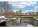 Back deck featuring a grill and seating area with views of the yard and neighborhood at 6227 Shenandoah Ave, Firestone, CO 80504