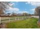Large backyard with white picket fence, lawn, and trees at 6227 Shenandoah Ave, Firestone, CO 80504