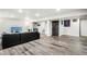 Open basement area featuring a large couch and durable flooring at 6227 Shenandoah Ave, Firestone, CO 80504