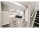 Basement with light gray floors and a dark colored couch at 6227 Shenandoah Ave, Firestone, CO 80504