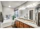Primary bath with double sinks, garden tub, granite countertop, and vanity at 6227 Shenandoah Ave, Firestone, CO 80504