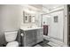 Modern bathroom featuring gray vanity, shower with subway tile, and updated fixtures at 6227 Shenandoah Ave, Firestone, CO 80504