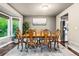 Dining room features a wooden table and chairs, a large window, and elegant decor at 6227 Shenandoah Ave, Firestone, CO 80504