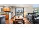 Open floor plan dining room with a wood table, hardwood floors, and access to the backyard patio at 6227 Shenandoah Ave, Firestone, CO 80504