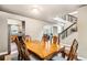 Dining room with a wooden table and ornate chairs next to the modern staircase at 6227 Shenandoah Ave, Firestone, CO 80504