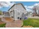 Exterior view of the home, featuring a patio, deck, and well-maintained lawn at 6227 Shenandoah Ave, Firestone, CO 80504