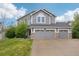 Charming two-story home with a three-car garage and well-maintained lawn in a suburban neighborhood at 6227 Shenandoah Ave, Firestone, CO 80504