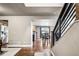 Welcoming foyer with hardwood floors, staircase, and an open view into the adjacent kitchen and dining room at 6227 Shenandoah Ave, Firestone, CO 80504
