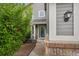 Inviting front entrance with a well-lit porch, tidy landscaping, and charming brick accents at 6227 Shenandoah Ave, Firestone, CO 80504