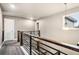 Hallway on the upper level has hardwood and carpet flooring with modern railing at 6227 Shenandoah Ave, Firestone, CO 80504