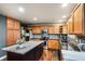 Modern kitchen featuring an island with granite countertops and stainless steel appliances at 6227 Shenandoah Ave, Firestone, CO 80504