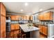 Bright kitchen with a large island, stainless steel appliances, and wood cabinetry at 6227 Shenandoah Ave, Firestone, CO 80504