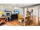 Open-concept layout showcasing the living room, dining area, stone fireplace, and staircase at 6227 Shenandoah Ave, Firestone, CO 80504