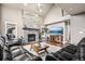 Spacious living room with vaulted ceilings, a stone fireplace, and modern entertainment setup at 6227 Shenandoah Ave, Firestone, CO 80504
