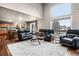 Bright, open-concept living room with hardwood floors seamlessly connects to the kitchen and dining area at 6227 Shenandoah Ave, Firestone, CO 80504