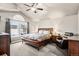Vaulted primary bedroom with a king bed, a ceiling fan, and neutral decor at 6227 Shenandoah Ave, Firestone, CO 80504