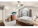 Spacious bedroom with great window views, soft carpet, dresser, and a TV at 6227 Shenandoah Ave, Firestone, CO 80504