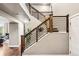 Staircase with modern railing and a beautiful plant to add some greenery at 6227 Shenandoah Ave, Firestone, CO 80504
