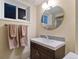 Well-lit bathroom with a modern vanity, round mirror, and neutral color scheme for a clean aesthetic at 806 S Jersey St, Denver, CO 80224