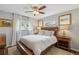 Cozy bedroom with wood-frame bed, neutral walls, light-colored bedding, and natural light from the windows at 806 S Jersey St, Denver, CO 80224