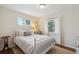 Light, bright bedroom with white bedding, a patterned rug, and large windows for plenty of natural light at 806 S Jersey St, Denver, CO 80224