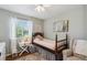 Comfortable bedroom with a wooden bed frame, soothing light green walls, and natural light at 806 S Jersey St, Denver, CO 80224